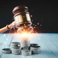 OldWoodJudgeHammerWithStackingCoinsInClose-upAnd