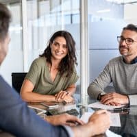 SmilingMatureCoupleMeetingWithBankManagerForInvestmentMid SmilingMatureCoupleMeetingWithBankManagerForInvestmentMid